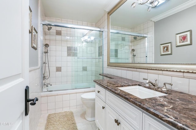 full bathroom featuring toilet, bath / shower combo with glass door, tile patterned floors, crown molding, and vanity