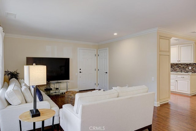 living room featuring hardwood / wood-style floors and ornamental molding