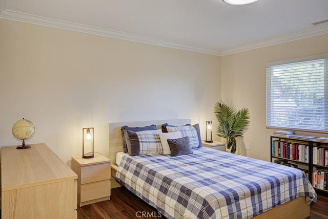 bedroom featuring crown molding and dark hardwood / wood-style floors