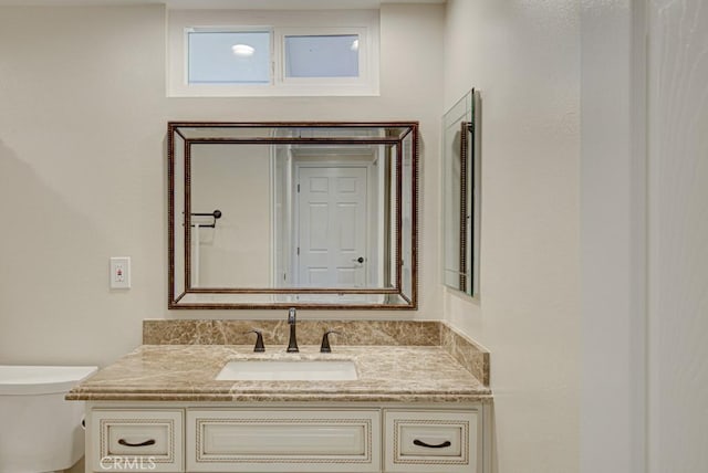 bathroom featuring toilet and vanity