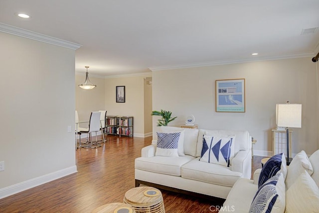 living room with dark hardwood / wood-style flooring and ornamental molding