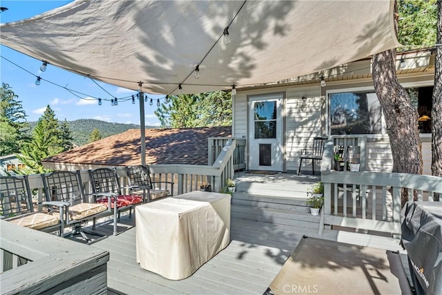 wooden deck featuring a mountain view