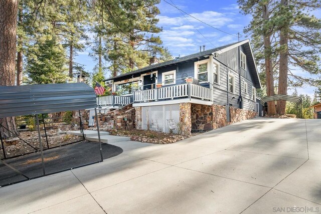 view of front of property with covered porch and a carport