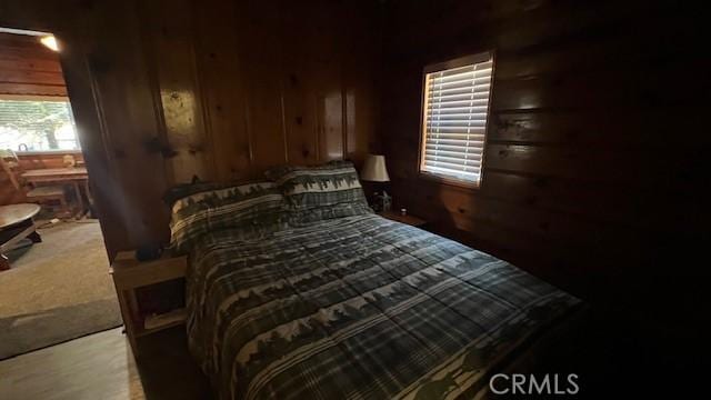 bedroom with wood walls