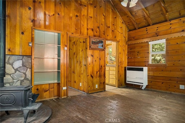 living room with wood-type flooring, vaulted ceiling with beams, a wood stove, wooden ceiling, and heating unit