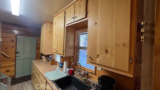 kitchen with light hardwood / wood-style flooring, light brown cabinets, and sink