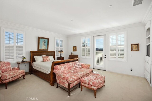 carpeted bedroom featuring ornamental molding, access to outside, and multiple windows