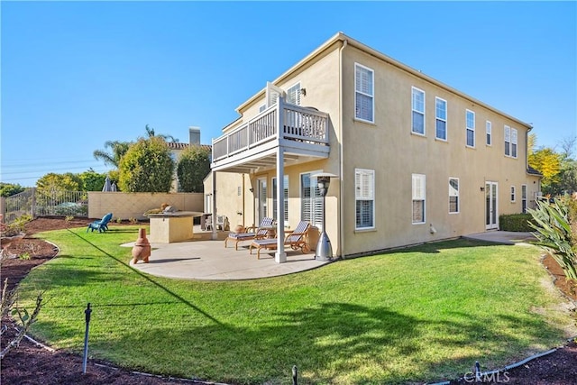 rear view of house with a yard and a patio area