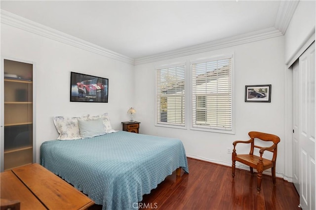 bedroom featuring dark hardwood / wood-style floors, a closet, and ornamental molding