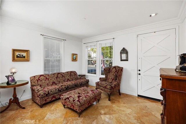 living area featuring crown molding