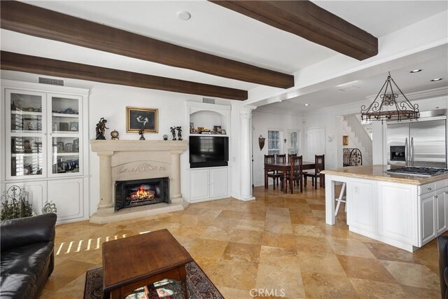 living room featuring crown molding and beam ceiling