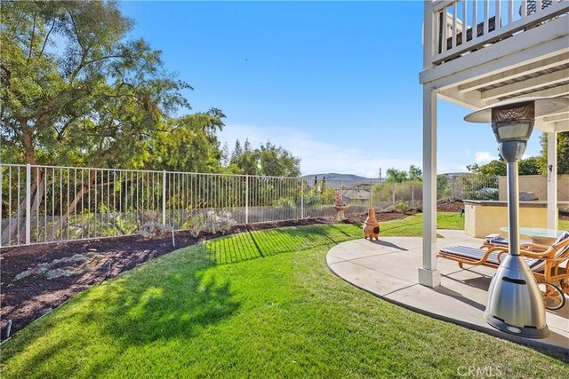 view of yard featuring a mountain view and a patio