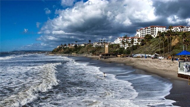 view of street with a beach view and a water view