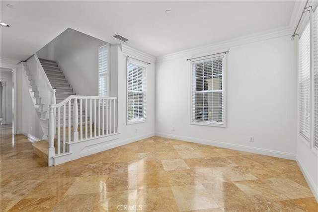 empty room with visible vents, ornamental molding, stairs, and baseboards