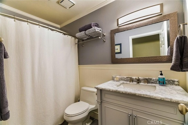 bathroom featuring crown molding, vanity, and toilet