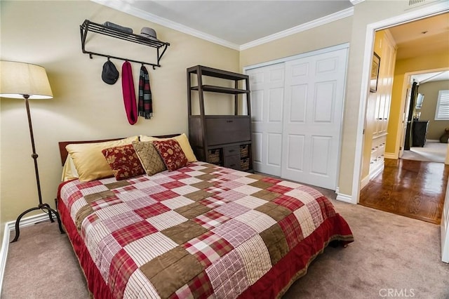 bedroom with crown molding, light colored carpet, and a closet