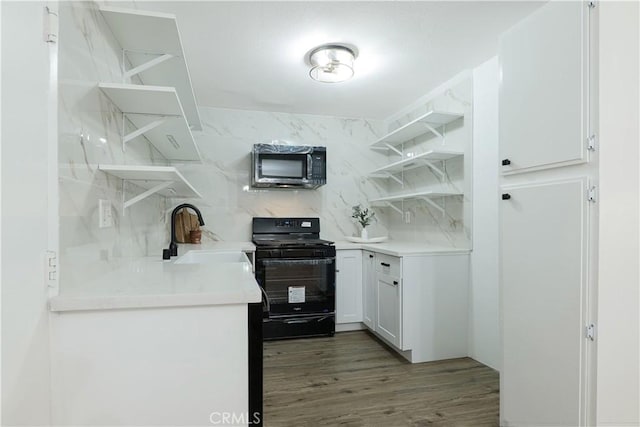 kitchen featuring backsplash, dark wood-type flooring, black appliances, white cabinets, and sink