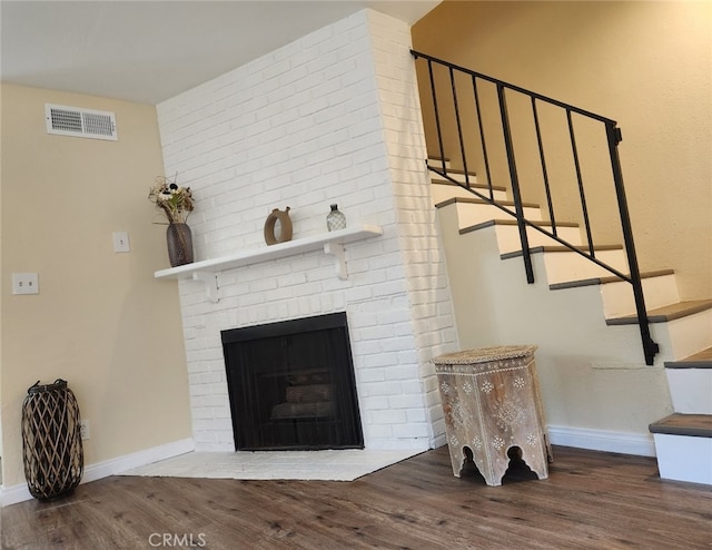 living room featuring wood-type flooring and a fireplace