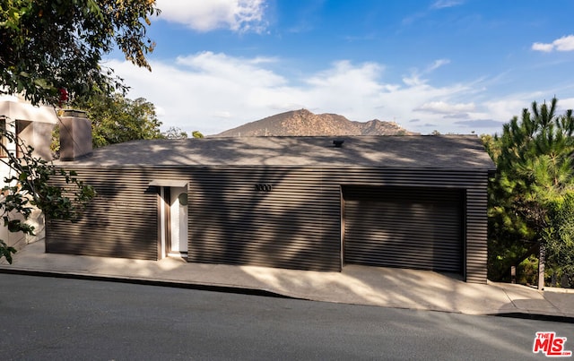 view of side of home featuring a mountain view and a garage