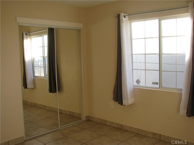 tiled spare room featuring plenty of natural light