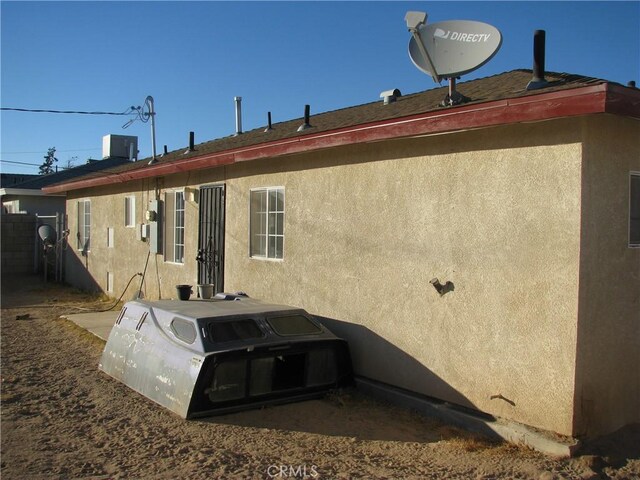 rear view of house with central AC unit