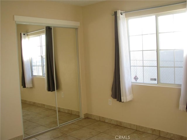 tiled empty room with a healthy amount of sunlight