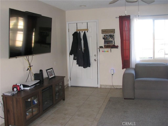 tiled living room with ceiling fan