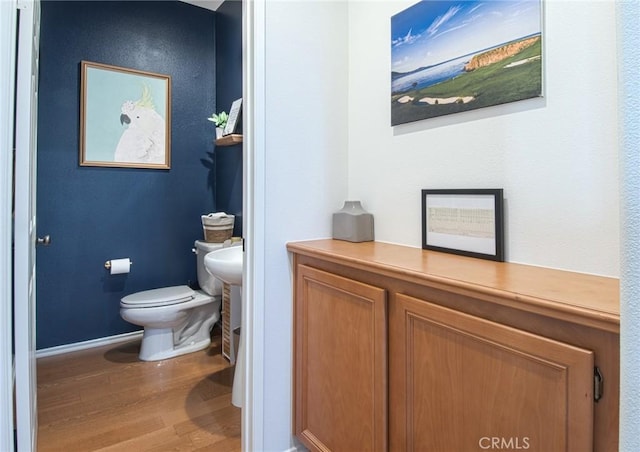 bathroom featuring toilet and hardwood / wood-style flooring