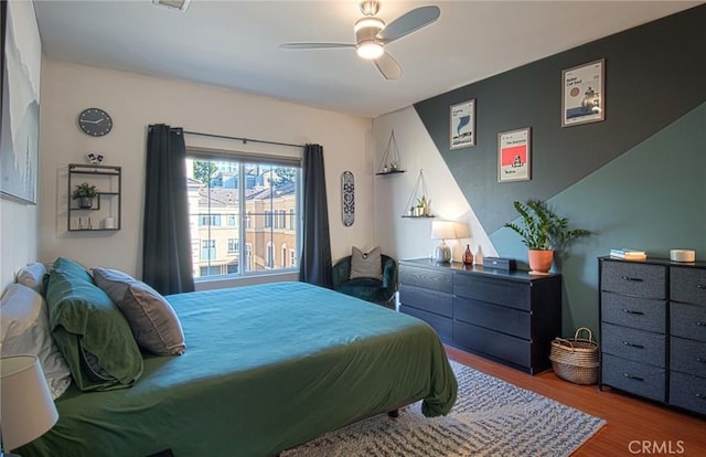 bedroom featuring ceiling fan and hardwood / wood-style floors