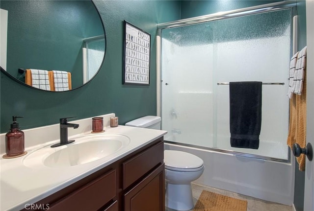 full bathroom with shower / bath combination with glass door, vanity, and toilet