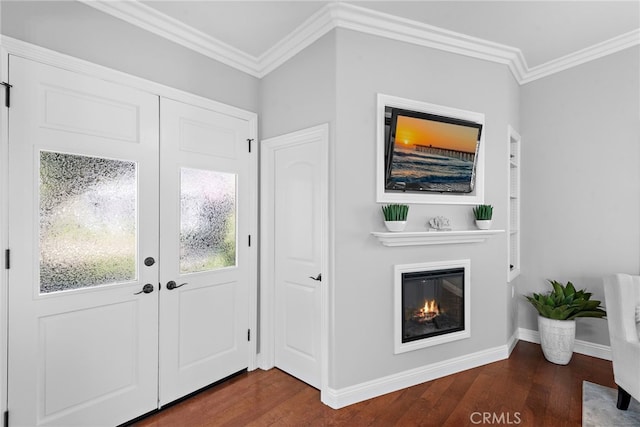 entryway with dark hardwood / wood-style flooring and crown molding