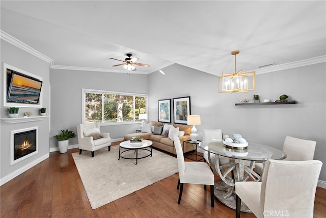 dining room featuring ceiling fan with notable chandelier, dark hardwood / wood-style flooring, and crown molding