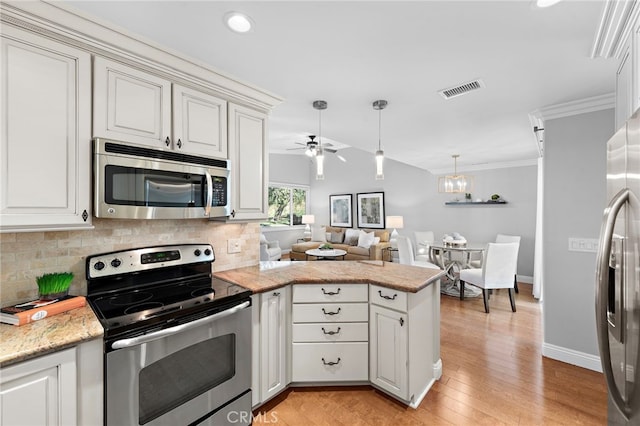 kitchen with appliances with stainless steel finishes, kitchen peninsula, decorative backsplash, light hardwood / wood-style flooring, and ceiling fan with notable chandelier