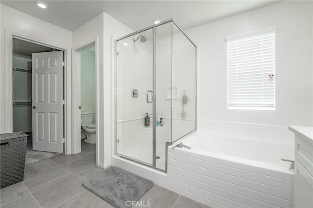 full bathroom with toilet, shower with separate bathtub, tile patterned floors, and vanity