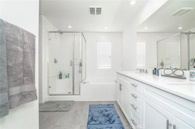 bathroom with tile patterned floors, vanity, and independent shower and bath