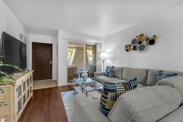 living room featuring a textured ceiling and dark hardwood / wood-style flooring