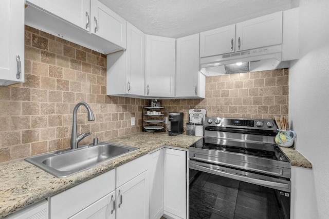 kitchen featuring white cabinets, backsplash, stainless steel range with electric cooktop, and sink