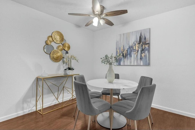 dining space with ceiling fan and dark hardwood / wood-style floors