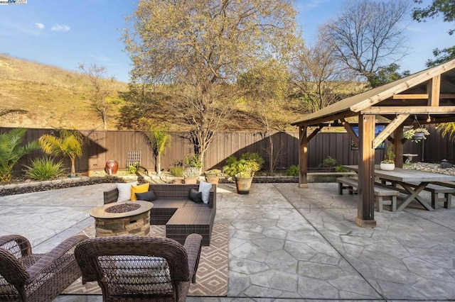 view of patio featuring a gazebo and an outdoor living space with a fire pit