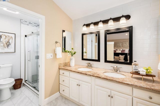 bathroom featuring vanity, vaulted ceiling, a shower with door, and toilet