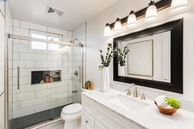 bathroom featuring vanity, walk in shower, and toilet