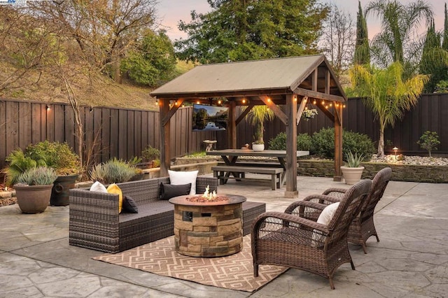 patio terrace at dusk with a gazebo and a fire pit