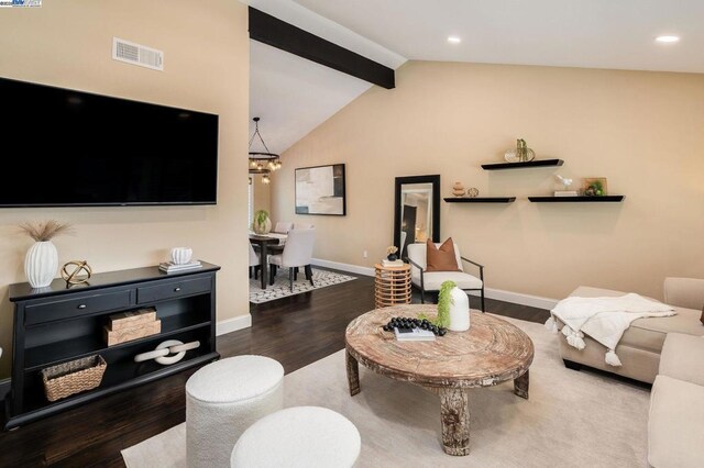 living room with dark hardwood / wood-style flooring, vaulted ceiling with beams, and a chandelier