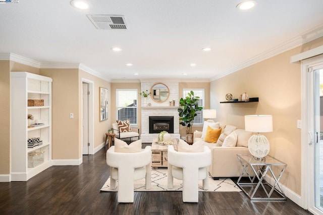 living room with crown molding, a fireplace, and dark hardwood / wood-style floors