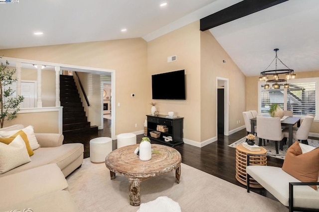 living room with vaulted ceiling with beams, a notable chandelier, and dark hardwood / wood-style flooring