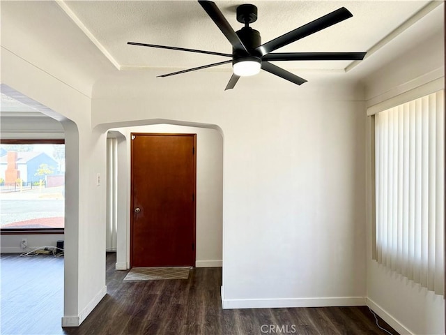 interior space featuring ceiling fan, dark hardwood / wood-style flooring, and a textured ceiling