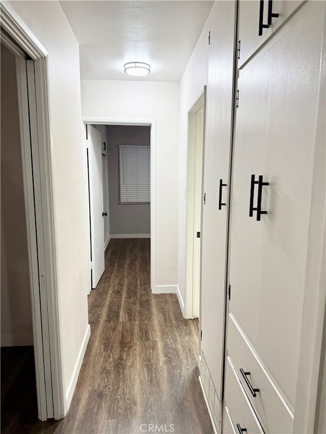 corridor with dark wood-type flooring