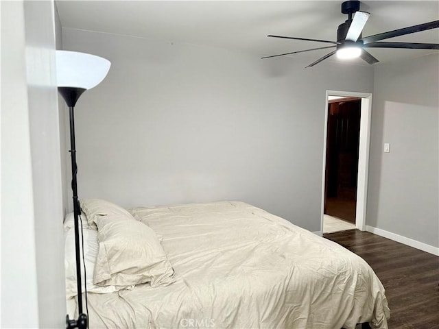 bedroom with dark wood-type flooring and ceiling fan