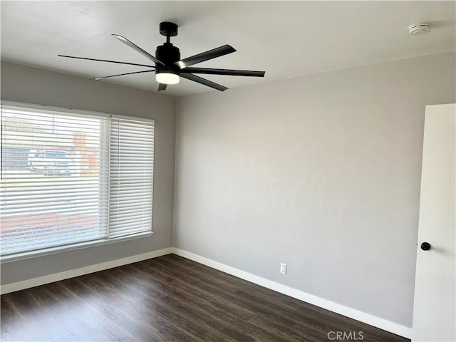 spare room with dark hardwood / wood-style floors and ceiling fan