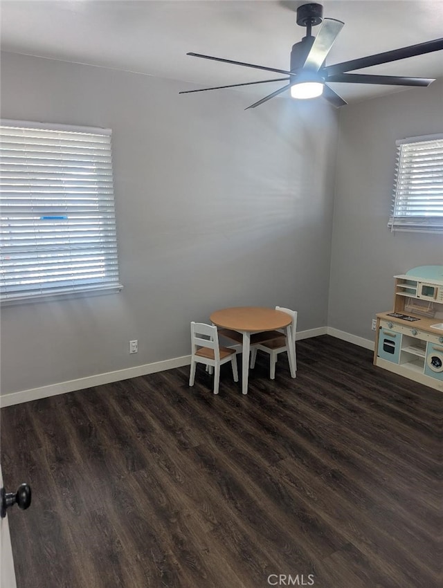 dining area with dark wood-type flooring and ceiling fan